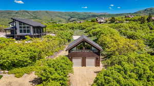 Aerial view of property and surrounding area with a mountainous background