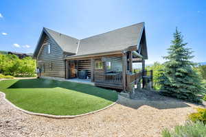 Back of property with roof with shingles and a patio area