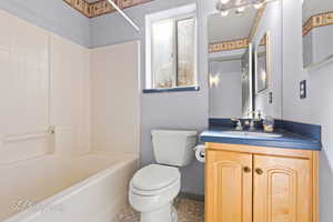 Full bathroom featuring vanity, shower / bathtub combination, and toilet