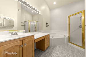 Bathroom featuring vanity, plus walk in shower, tile patterned flooring, and vaulted ceiling