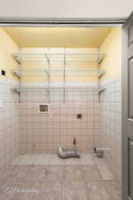 Bathroom with tile patterned floors and tile walls