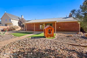 Rear view of house featuring a patio