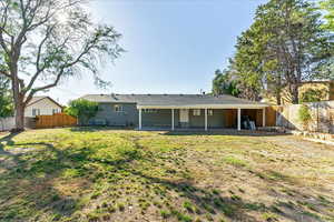 Back of house featuring a patio, a yard, and central AC