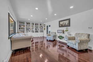 Freestanding White Bookcases and canned lighting in the elegant front room