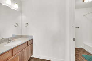 Bathroom featuring tile patterned flooring and vanity