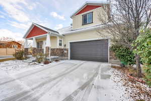 View of front of property featuring a porch and a garage