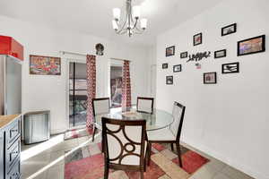 Tiled dining area with an inviting chandelier