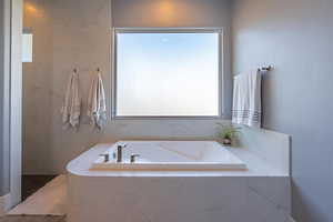 Bathroom with tiled tub