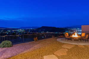 Patio at night with a mountain view and an outdoor fire pit