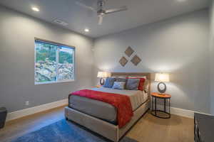 Bedroom with hardwood / wood-style flooring and ceiling fan