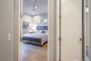 Bedroom with ceiling fan and light hardwood / wood-style flooring