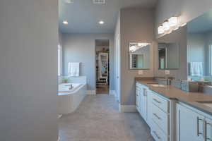 Bathroom with vanity and a relaxing tiled tub