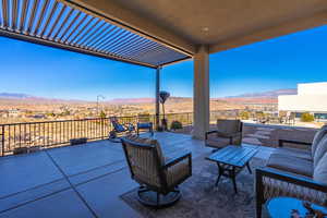 View of patio featuring an outdoor living space and a mountain view