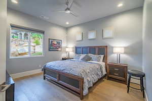 Bedroom with ceiling fan and light wood-type flooring