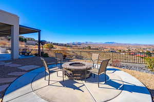 View of patio / terrace with a mountain view and a fire pit