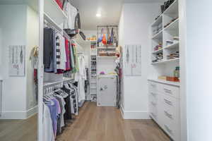 Walk in closet featuring light wood-type flooring