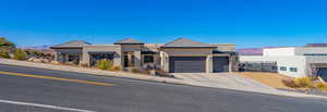 View of front facade with a garage and a mountain view