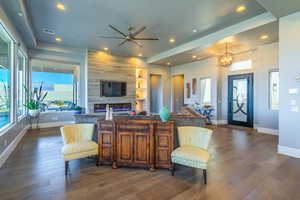 Interior space with an inviting chandelier, dark wood-type flooring, a fireplace, and built in features