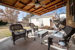 View of patio with an outdoor living space and ceiling fan