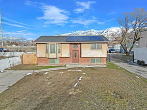 Bi-level home with a mountain view and solar panels