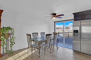 Dining space with ceiling fan, light hardwood / wood-style flooring, and a textured ceiling