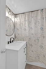 Bathroom with vanity and a textured ceiling