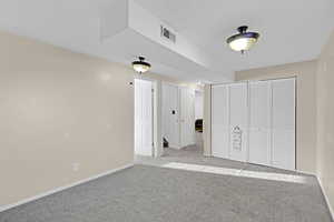 Unfurnished bedroom featuring light colored carpet