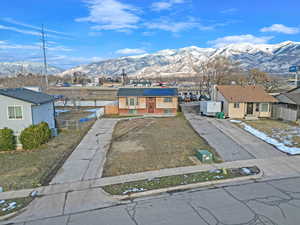 View of front of home featuring a mountain view and solar panels