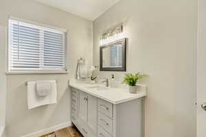 Bathroom featuring hardwood / wood-style flooring and vanity