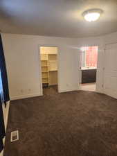 Primary bedroom featuring connected bathroom, Vaulted Ceilings &  Large walk in closet