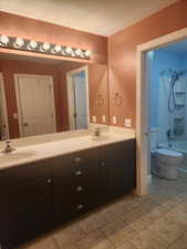 Full bathroom featuring shower / bath combination & double sinks