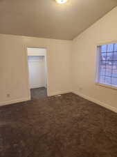 2nd bedroom view 2 with vaulted ceiling and walk in closet