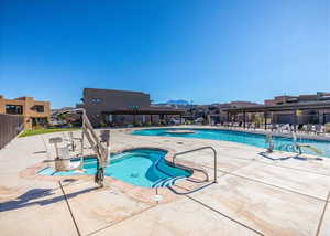 View of pool featuring pool water feature and a patio area