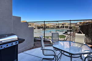 View of patio featuring area for grilling and a community pool