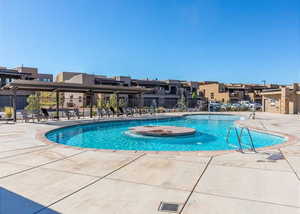 View of swimming pool with a patio, a pergola, and pool water feature