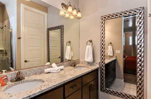 Bathroom with a shower with door and vanity