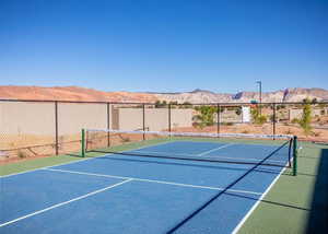 View of tennis court featuring a mountain view