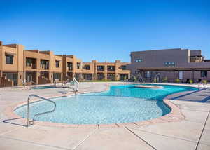 View of pool featuring pool water feature, a hot tub, and a patio area