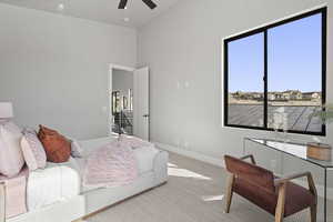 Carpeted bedroom featuring ceiling fan