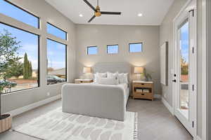 Tiled bedroom featuring access to outside and ceiling fan