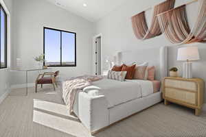 Carpeted bedroom featuring lofted ceiling