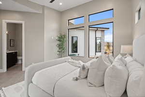 Tiled bedroom featuring ensuite bath