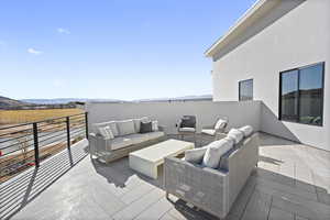 Wooden terrace featuring outdoor lounge area