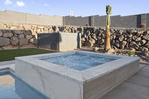 View of pool featuring an outdoor hot tub