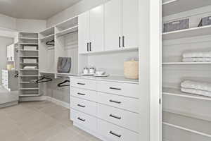 Spacious closet with light tile patterned floors