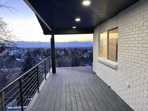 Deck at dusk featuring a mountain view