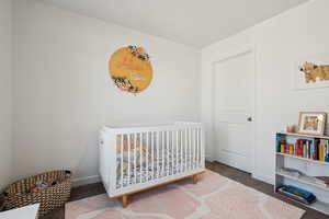 Bedroom featuring carpet and a crib