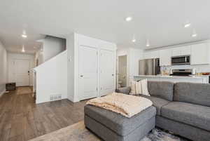 Living room featuring sink and hardwood / wood-style flooring