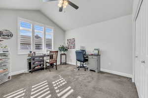 Office area with ceiling fan, lofted ceiling, and carpet floors