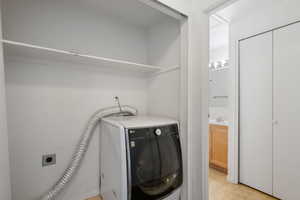 Laundry room with washer / dryer and sink